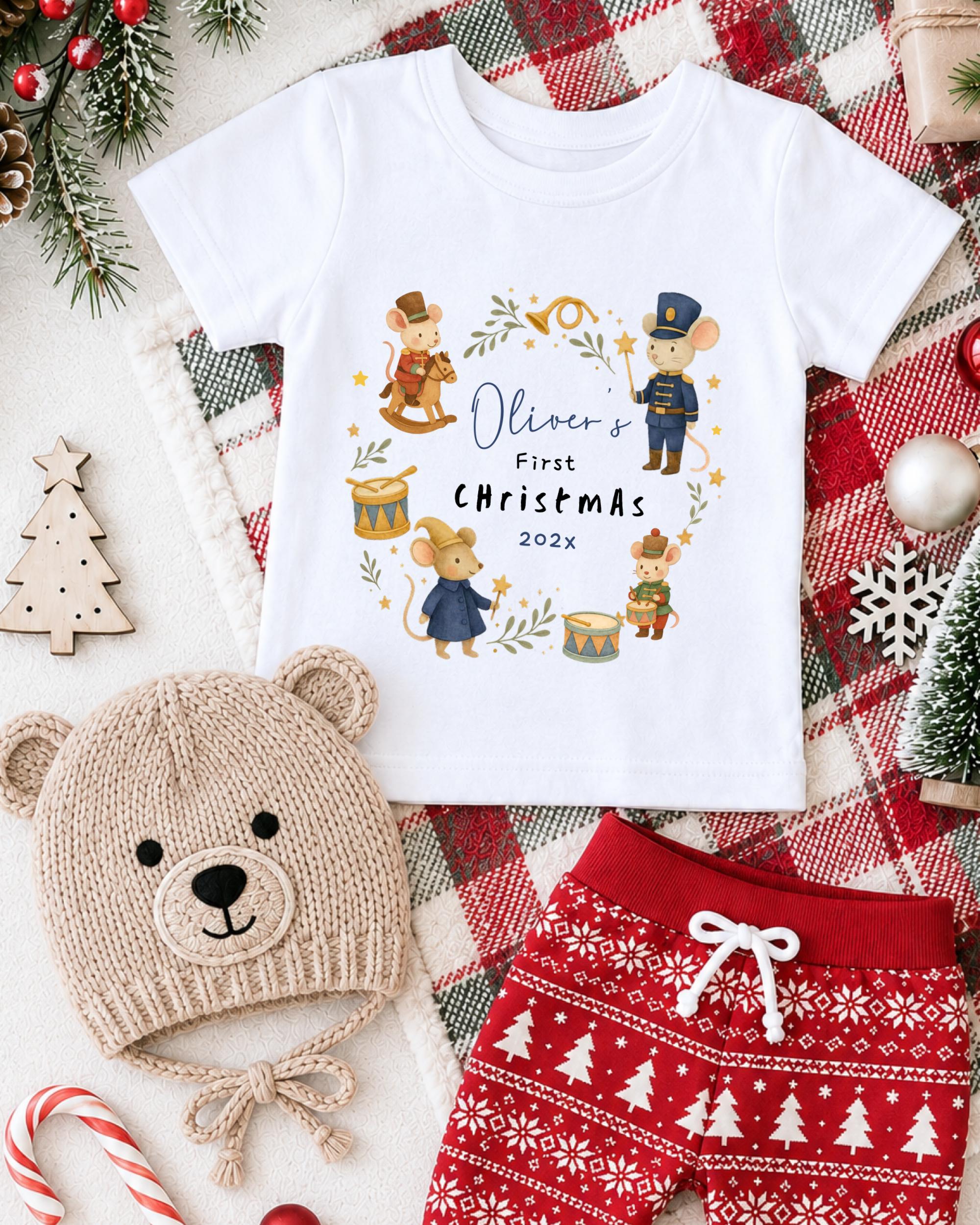 A white t-shirt with a Christmas-themed design, a knitted bear hat, and red patterned shorts, all surrounded by holiday decorations such as a Christmas tree, ornaments, and a snowflake.