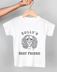A white t-shirt with a graphic design of a dog's face and the text "Sully's BEST FRIEND" printed on it.