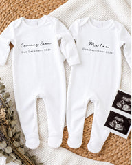 two white onesies with text that announces the upcoming arrival of a baby. The text on the onesies reads "Coming Soon Due December 202x" and "Me too Due December 202x".