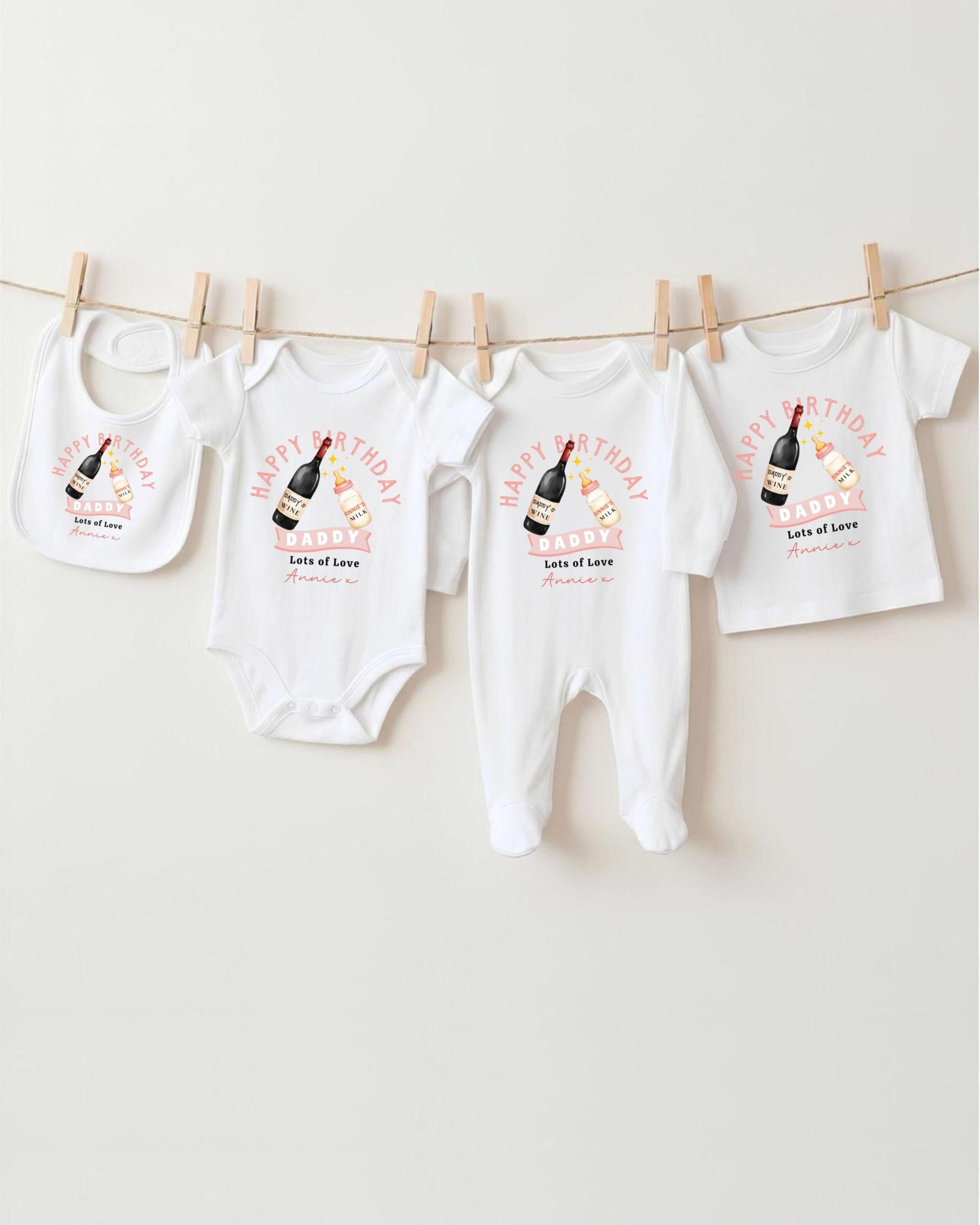 A collection of white baby clothes, including onesies and bibs, hanging on a clothesline.