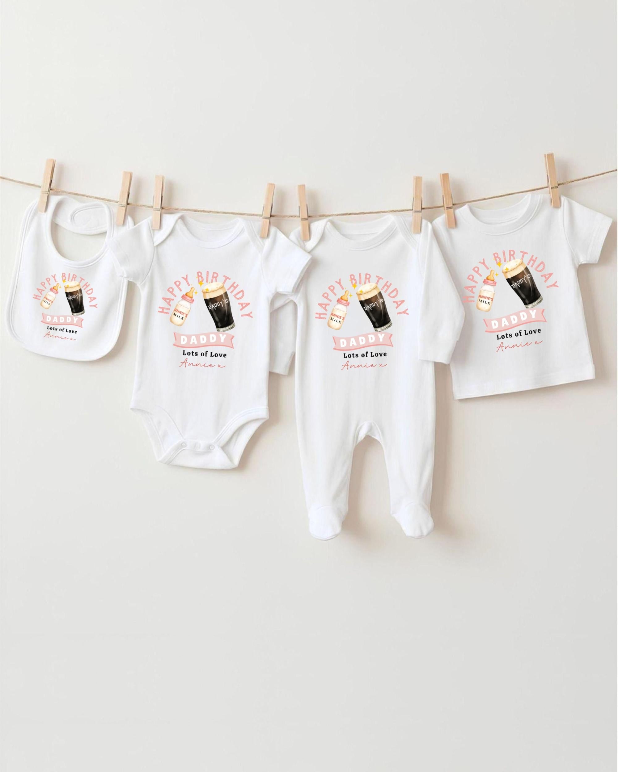 A collection of white baby clothes, including onesies and bibs, hanging on a clothesline.