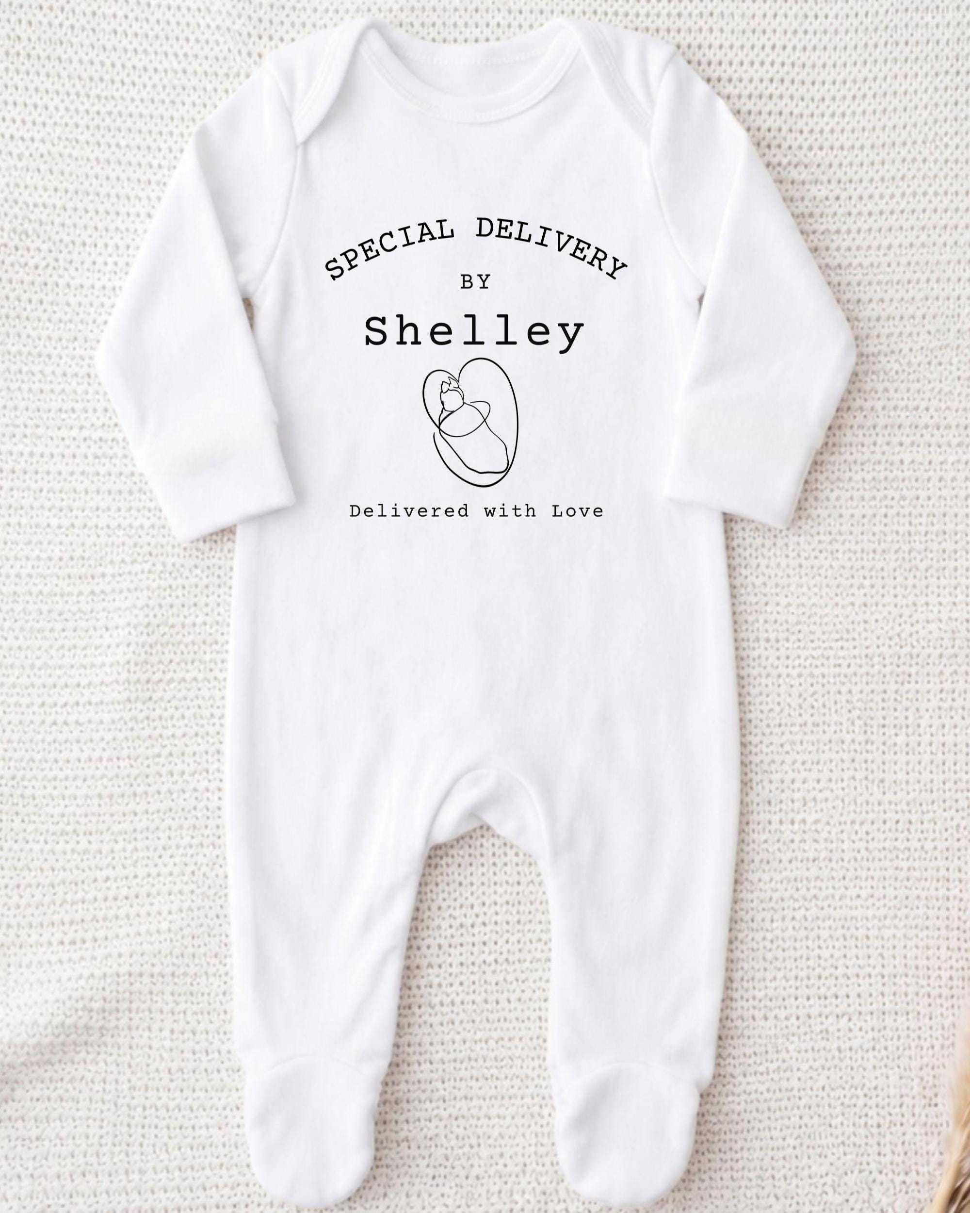 A white onesie with text and a graphic printed on it.