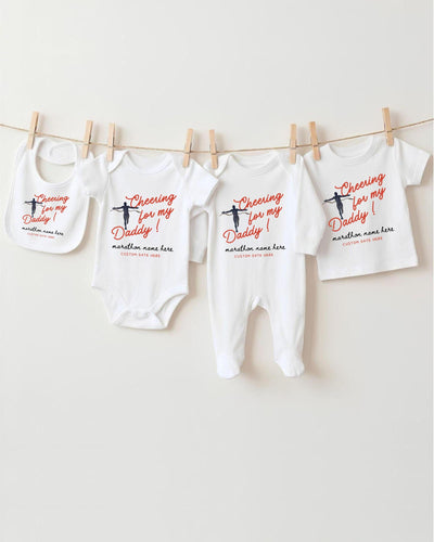 a collection of baby clothes hanging on a clothesline, with each piece featuring a unique design and text.