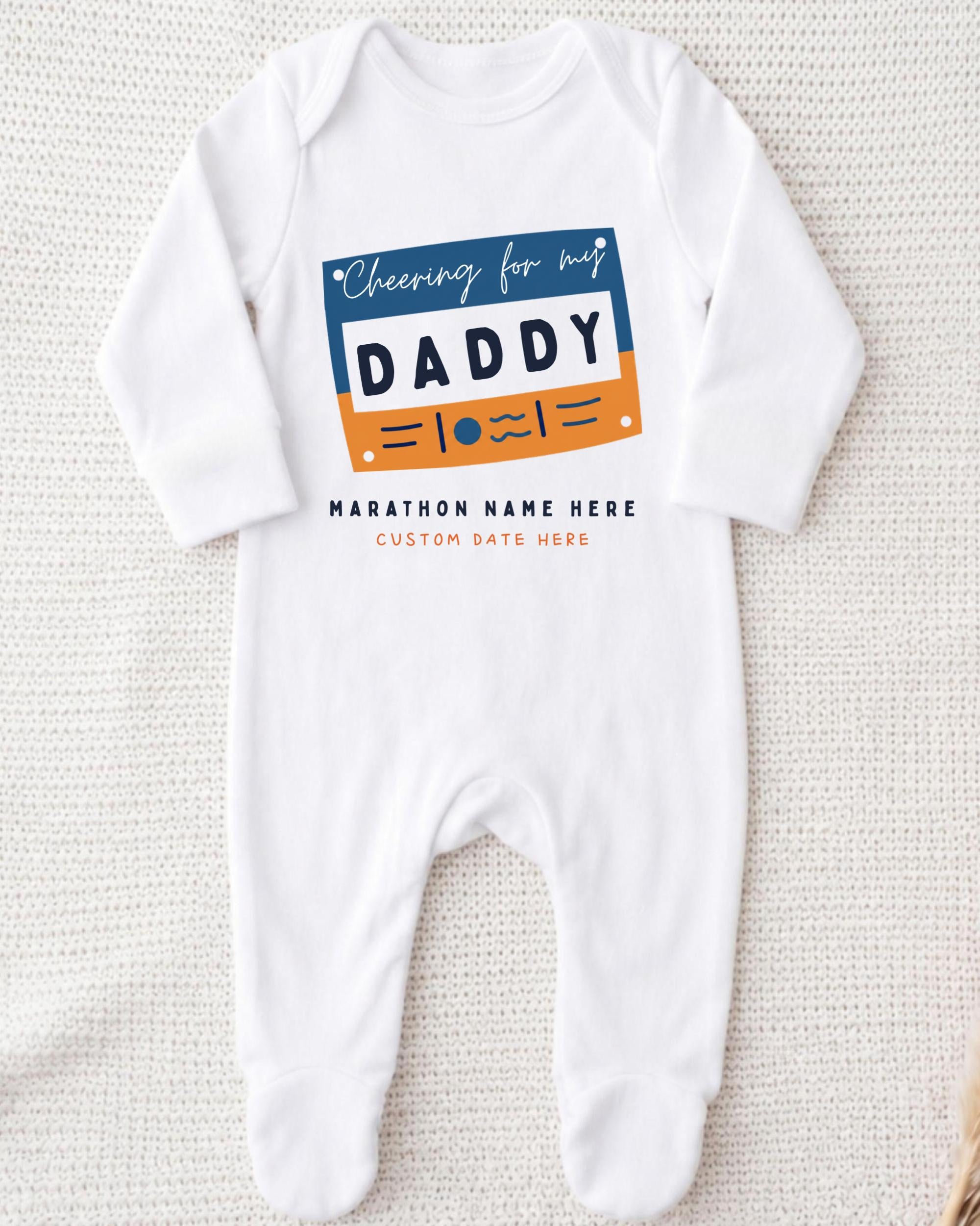 A white onesie with a graphic design on it, featuring the text "Cheering for my DADDY" and "MARCHON NAME HERE" along with a custom name.