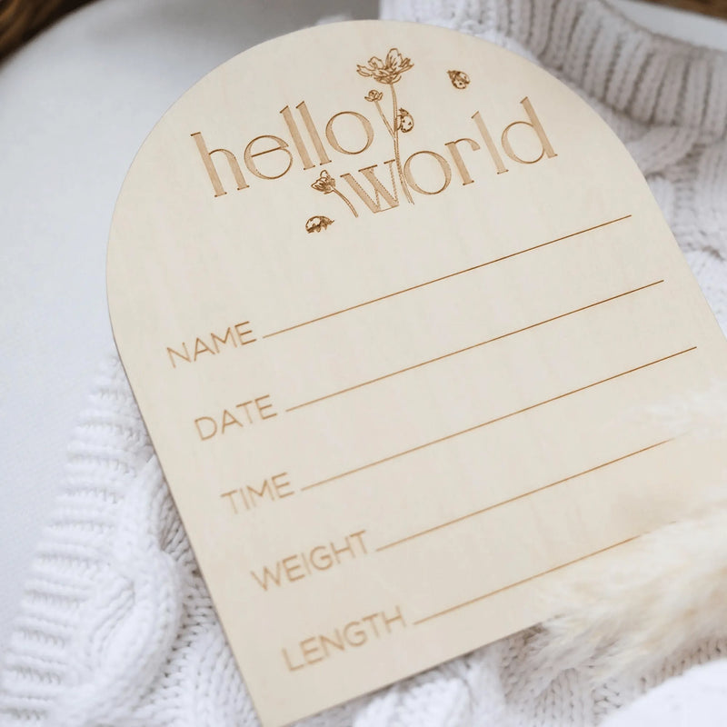 a wooden name tag attached to a white sweater