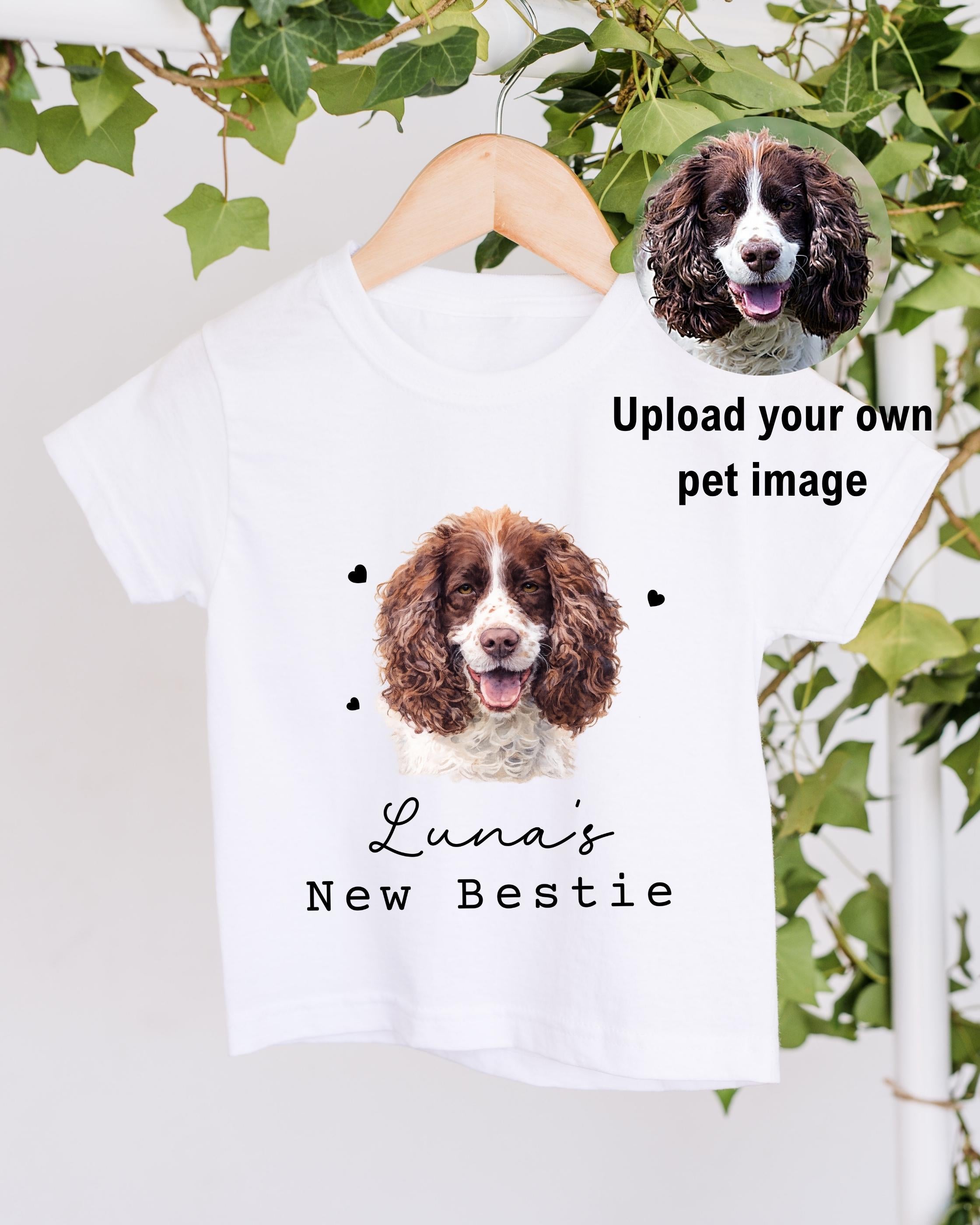 A white t-shirt with a picture of a brown and white dog, along with the text "Luna's New Bestie" printed on it.