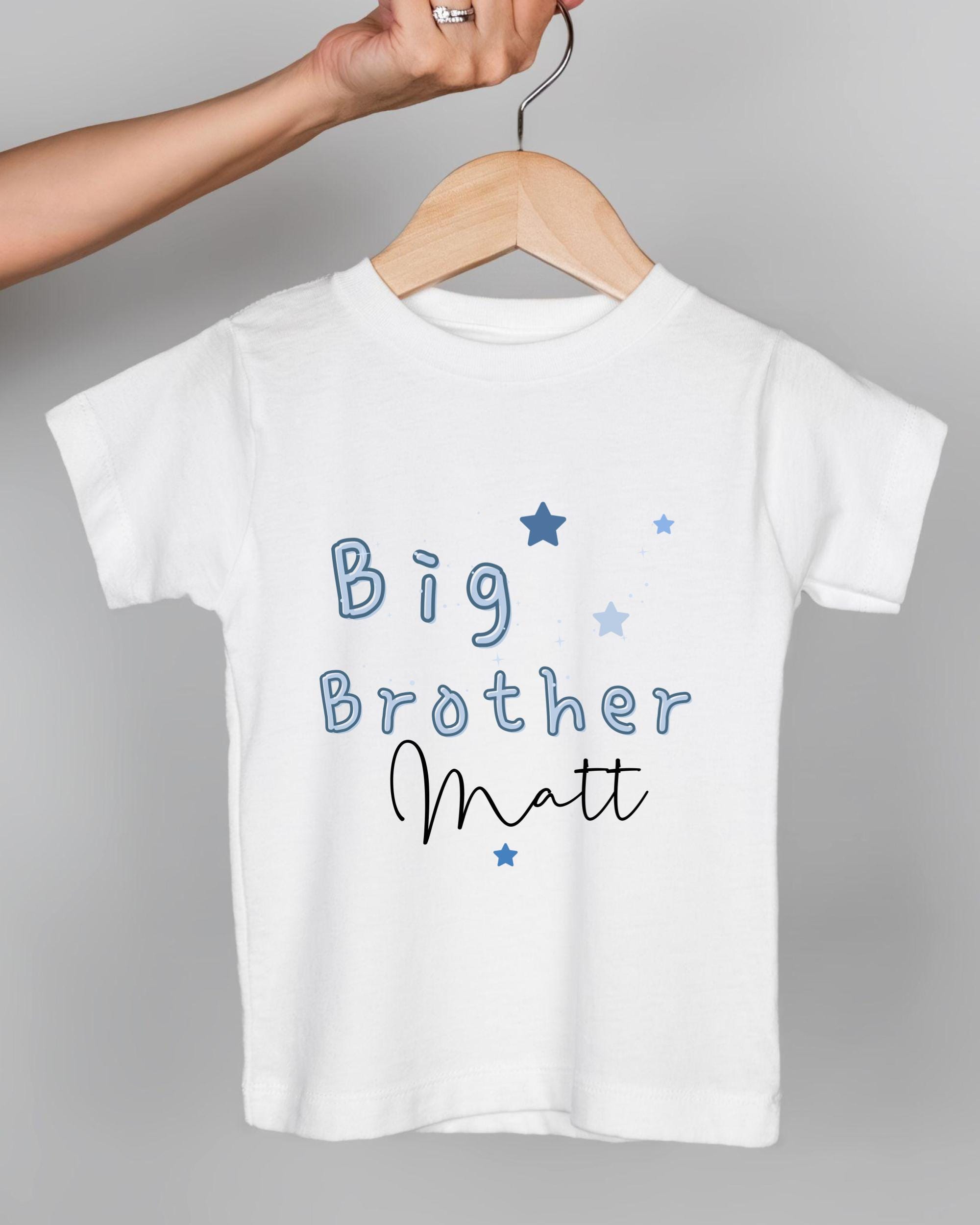 A white t-shirt with the text "Big Brother Matt" printed on it, along with blue stars.