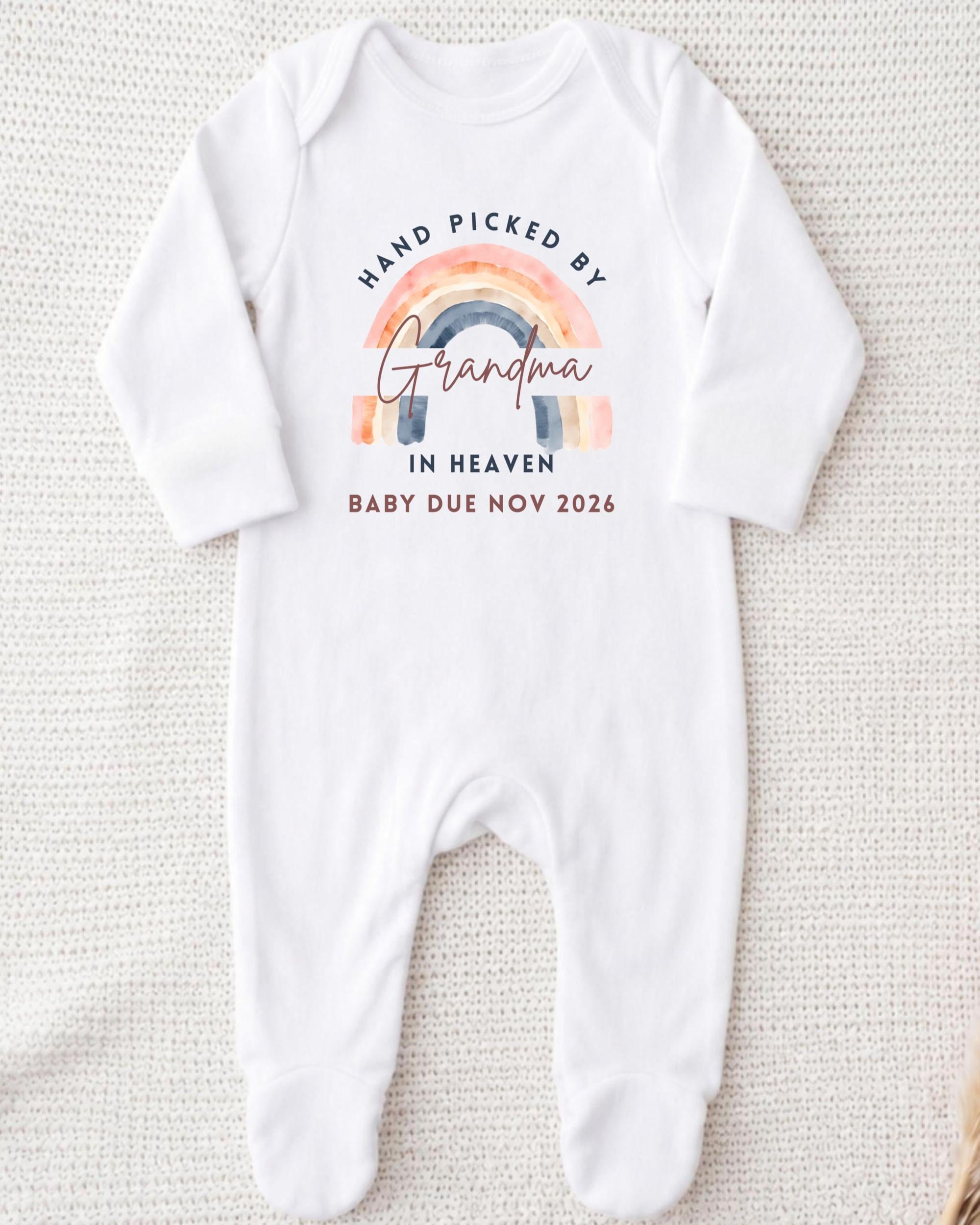 A white onesie with a graphic design and text on it.