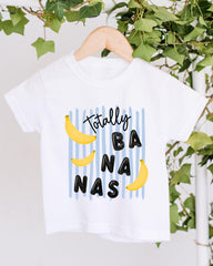 A white t-shirt with a graphic design featuring bananas and the text "Totally BANANA" printed on it.