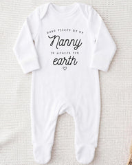 A white onesie with the text "Hand picked by my Nanny in heaven for earth" printed on it.