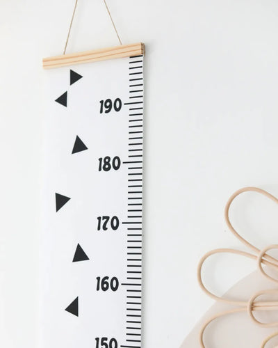 a ruler hanging on a wall next to a pair of scissors