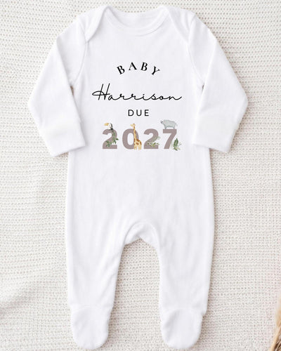 Personalised white Bib with 'Baby Harrison Due 2027' lettering, with safari animals decorating the year for a safari pregnancy announcement.