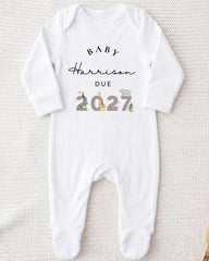A white onesie with text and illustrations on it.