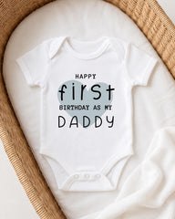 A white onesie with text printed on it, placed in a woven basket.