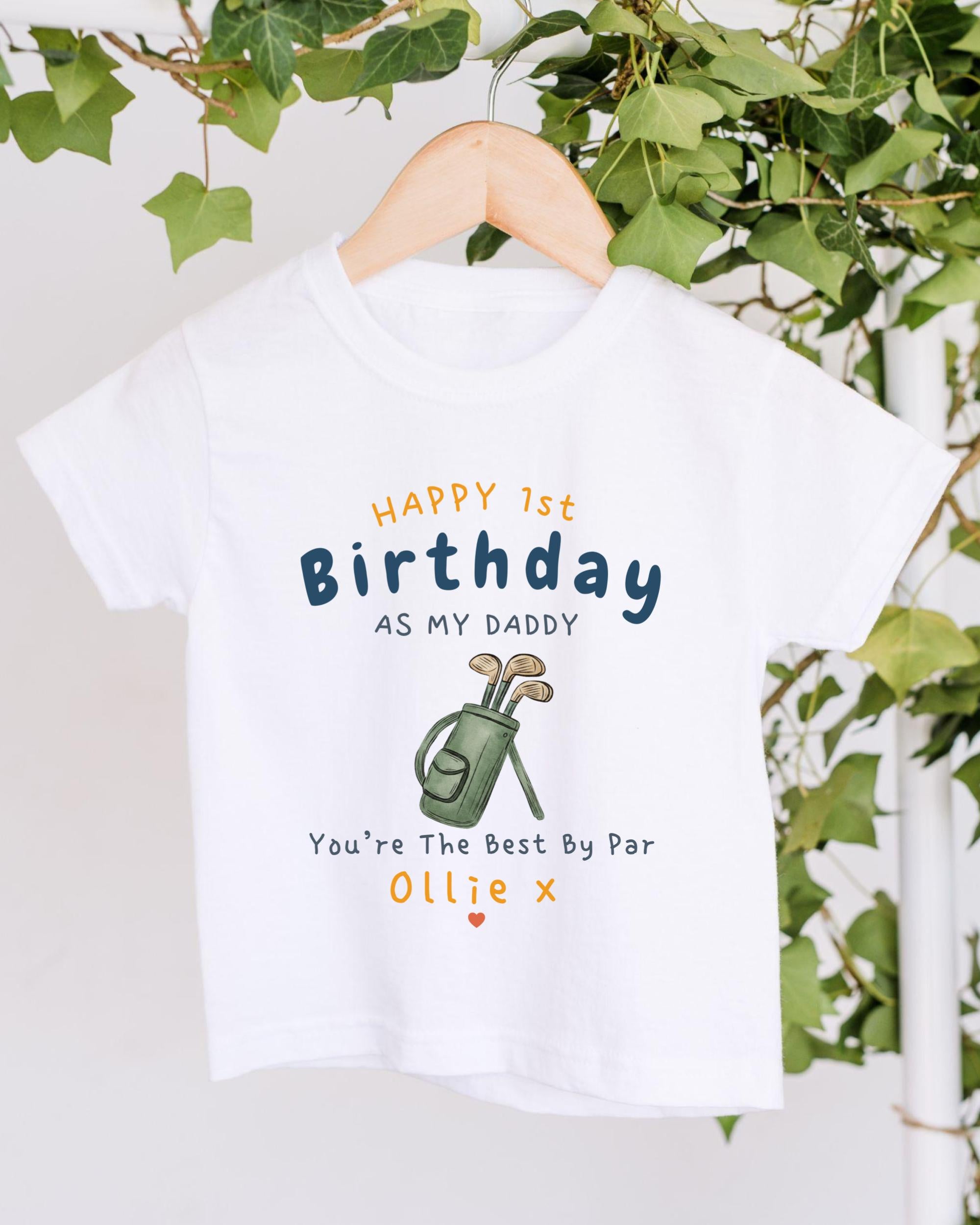A white t-shirt with a personalized message printed on it, hanging on a wooden hanger.