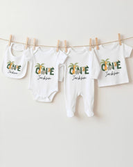 A collection of white baby clothes, including onesies and pajamas, hanging on a clothesline.