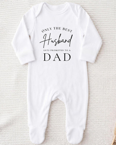 A white bodysuit with the text "Only the best husband gets promoted to a dad" printed on it.