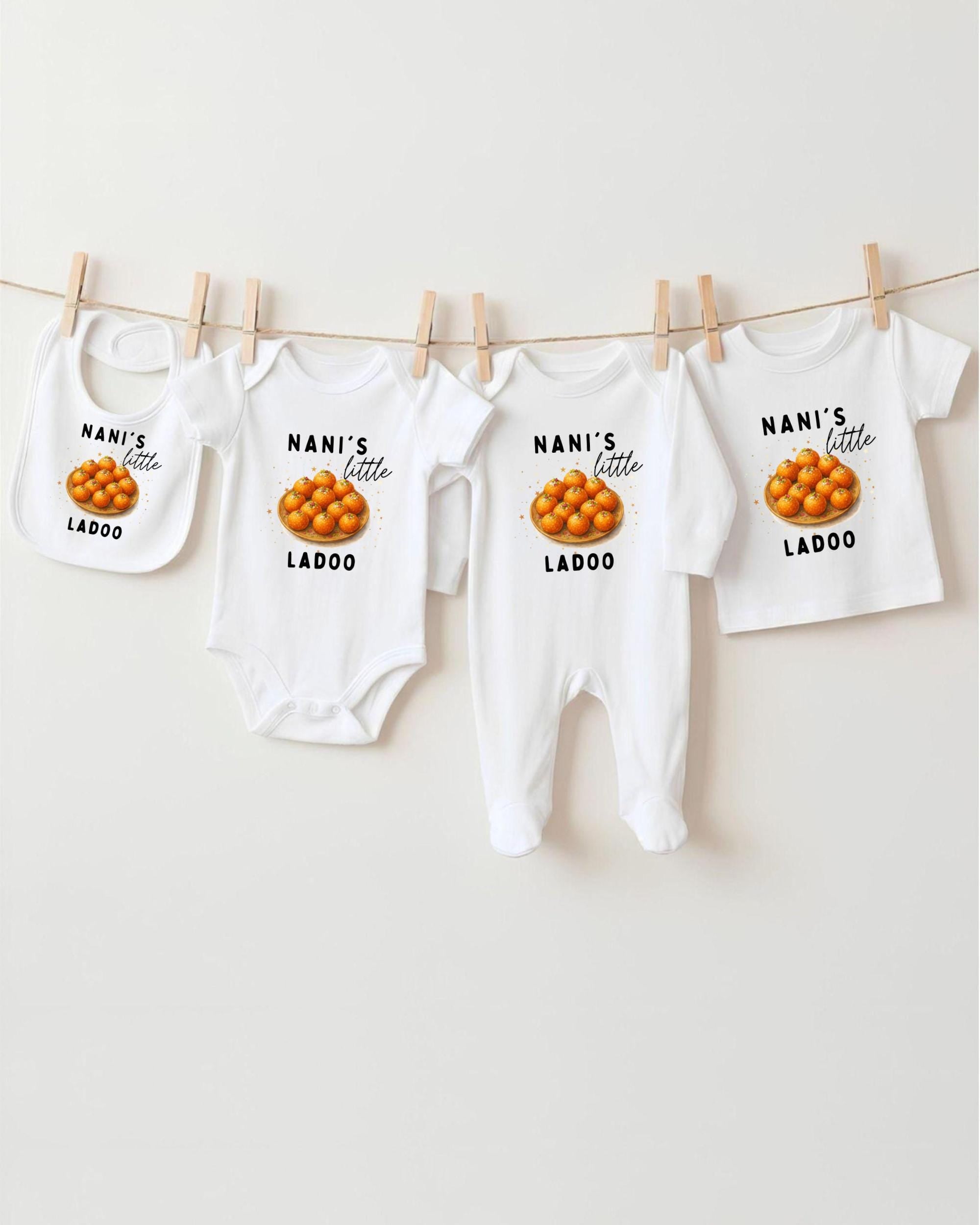 A row of white baby clothes with the text "NANI'S LITTLE LADOO" printed on them, along with an image of oranges.