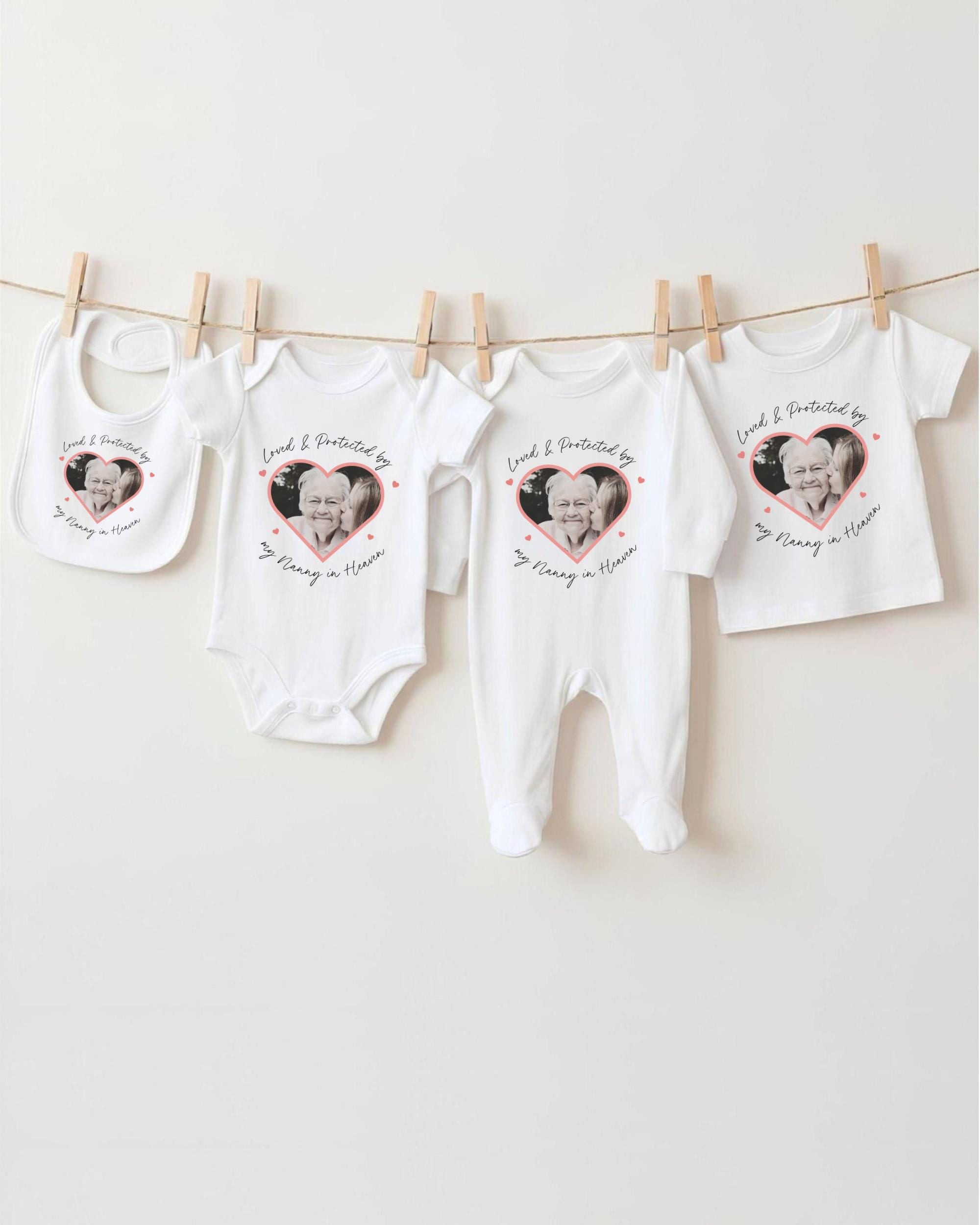 a collection of white baby clothes and bibs hanging on a clothesline, each featuring a heart-shaped design with a photograph of an elderly person.