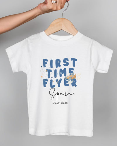 A white t-shirt with the text "FIRST TIME FLYER Spain July 2023" printed on it.