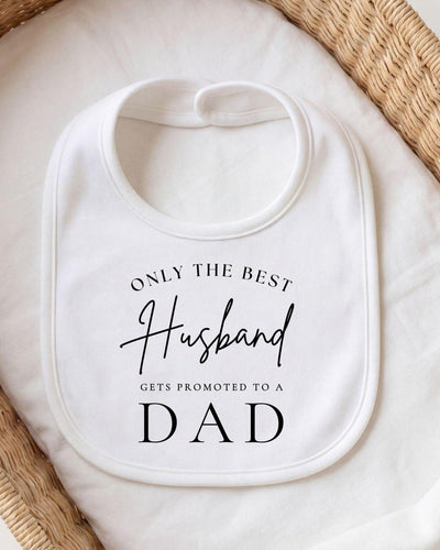 A white bib with black text that reads "ONLY THE BEST Husband gets promoted to a DAD".