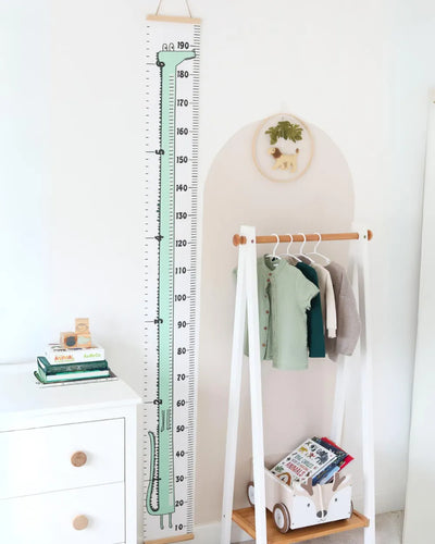a room with a white wall and a tall ruler on the wall