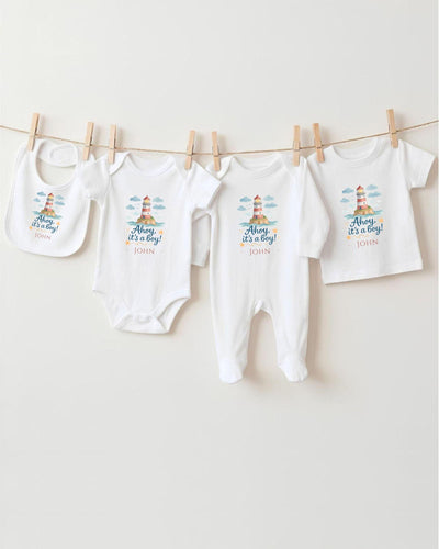 A row of four white baby clothes, including onesies and bibs, hanging on a clothesline.