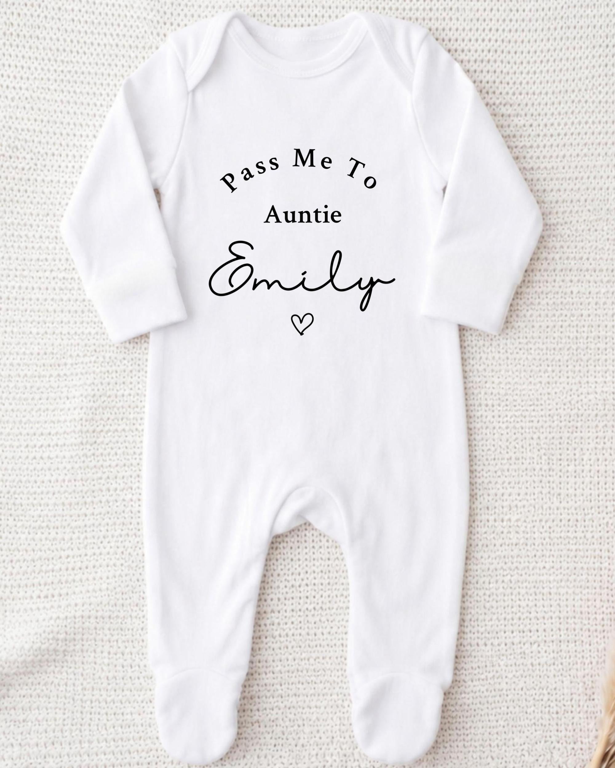 A white onesie with the text "Pass Me To Auntie Emily" printed on it.