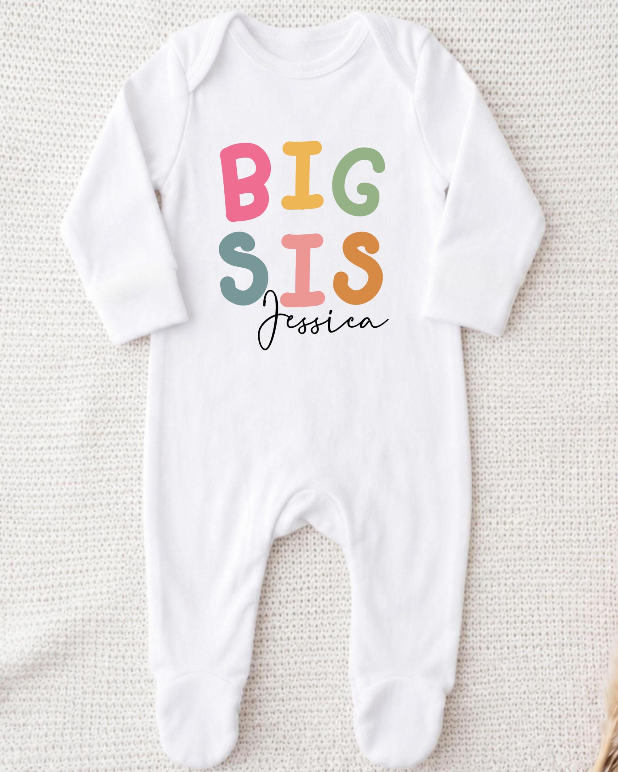A white onesie with the text "BIG SIS Jessica" printed on it.