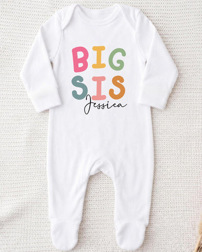 A white bodysuit with the text "BIG SIS Jessica" printed on it.