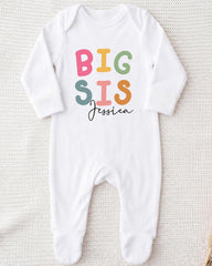 A white onesie with the text "BIG SIS Jessica" printed on it.