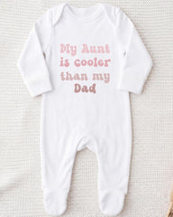 A white onesie with the text "My Aunt is cooler than my Dad" printed on it.