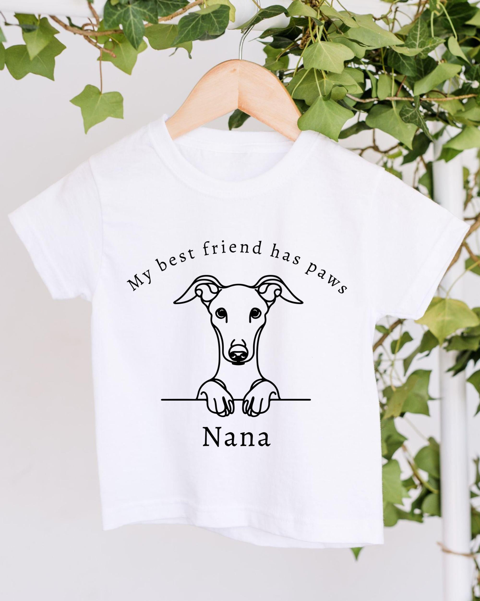 A white t-shirt with a black graphic design depicting a dog's head and paw, along with the text "My best friend has paws" and "Nana" printed on it.