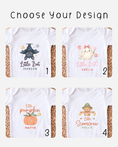 four different baby bodysuits with various designs, including a bat, a ghost, a pumpkin, and a scarecrow.