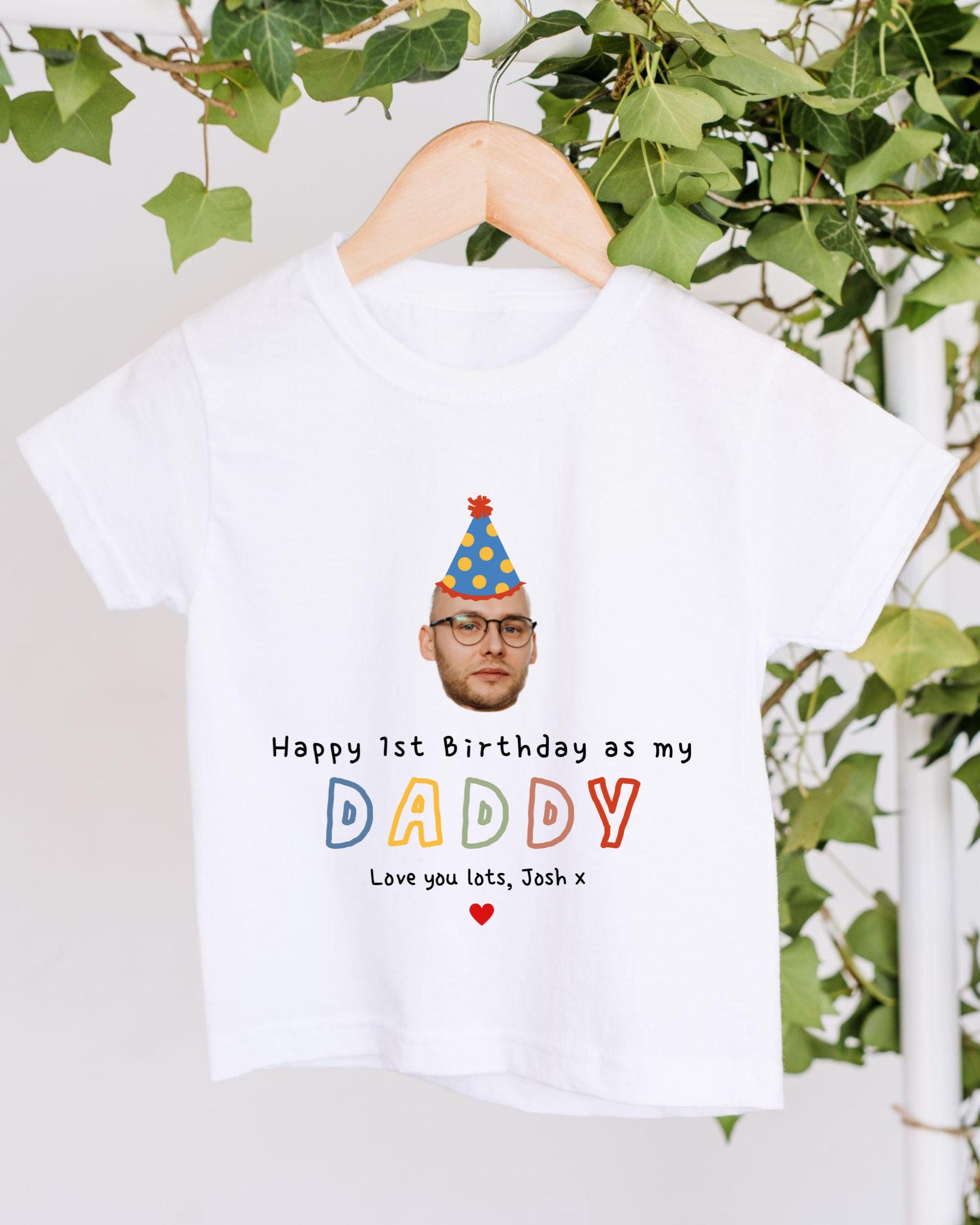 A white t-shirt with a personalized birthday message and a picture of a person wearing a party hat.
