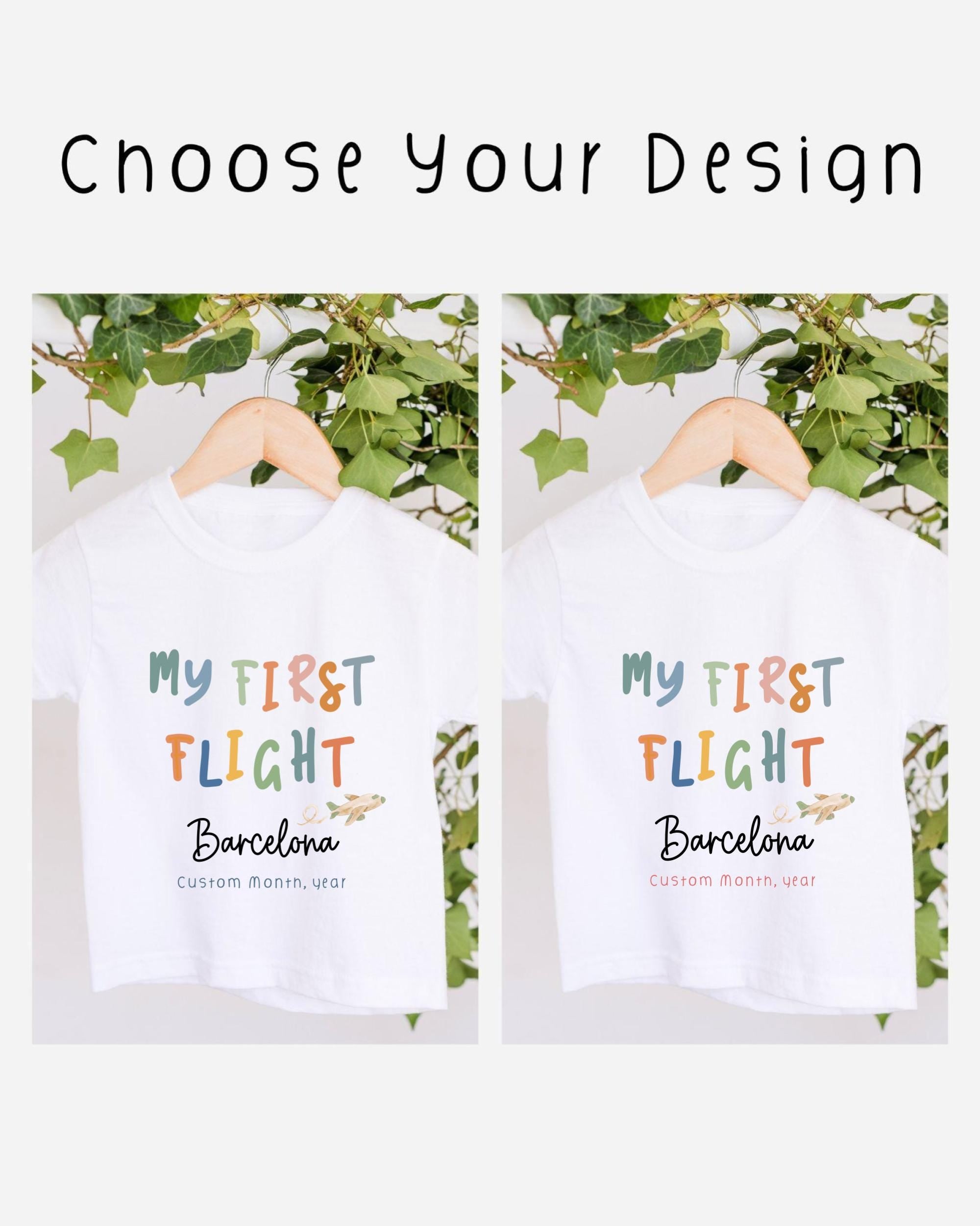 two white t-shirts with the text "My first flight Barcelona Custom Month, year" printed on them. The t-shirts are hanging on a wooden hanger, with a plant visible in the background.