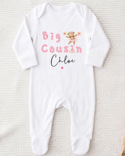 A white bodysuit with the text "Big Cousin Chloe" printed on it, along with a small illustration of a teddy bear.