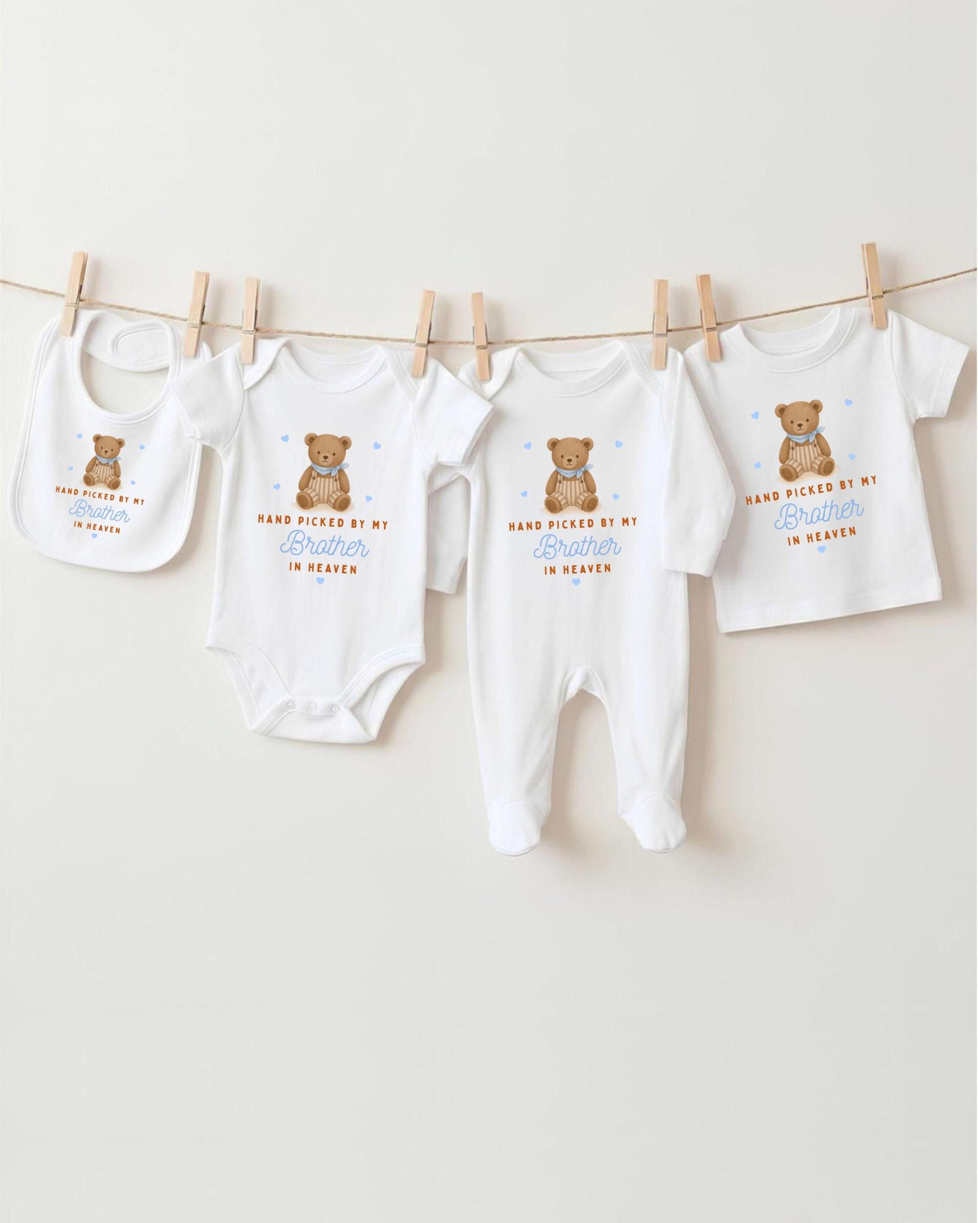 A collection of baby clothes, including onesies and bibs, hanging on a clothesline.