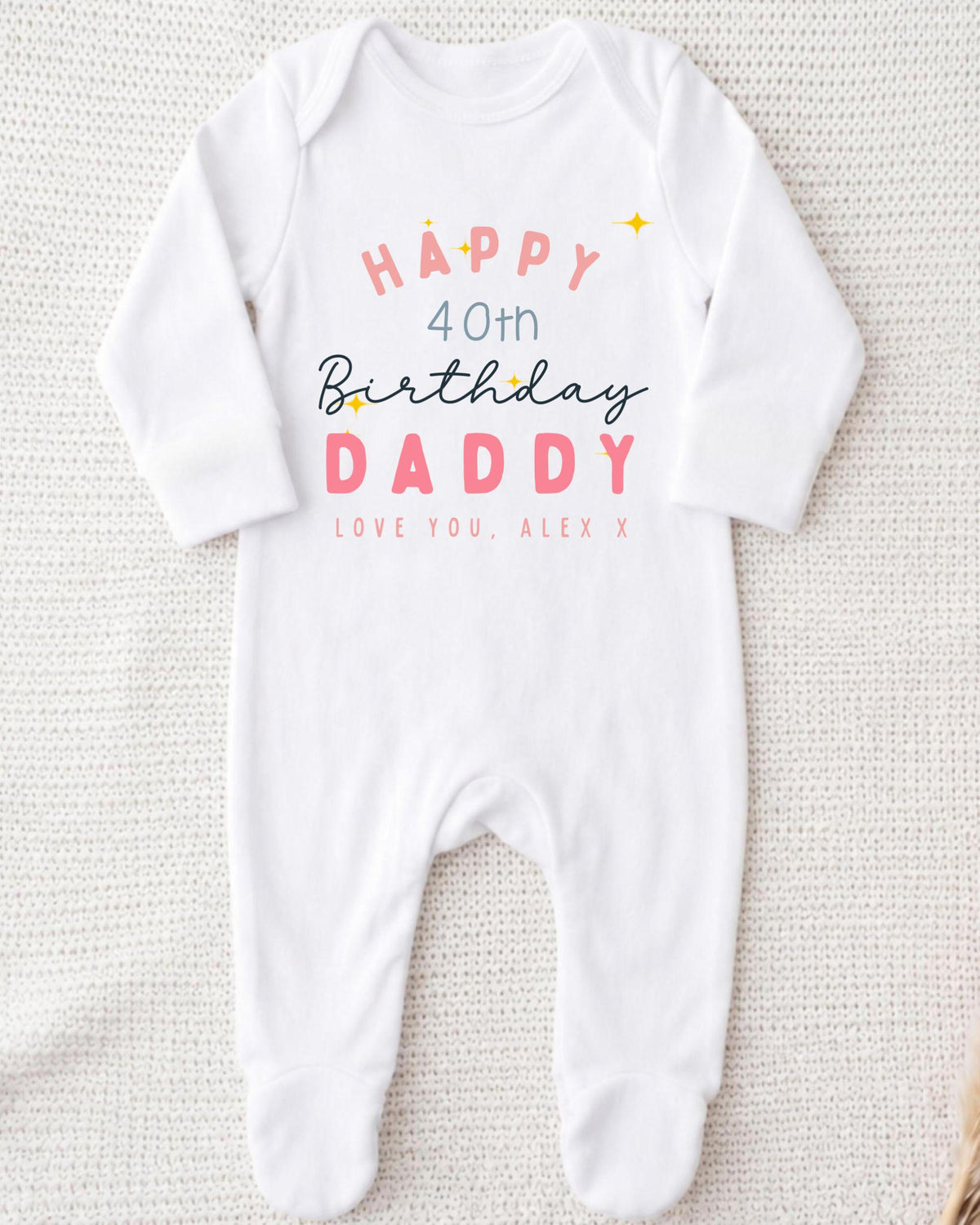 A white onesie with text and graphics printed on it, celebrating a 40th birthday for a father.
