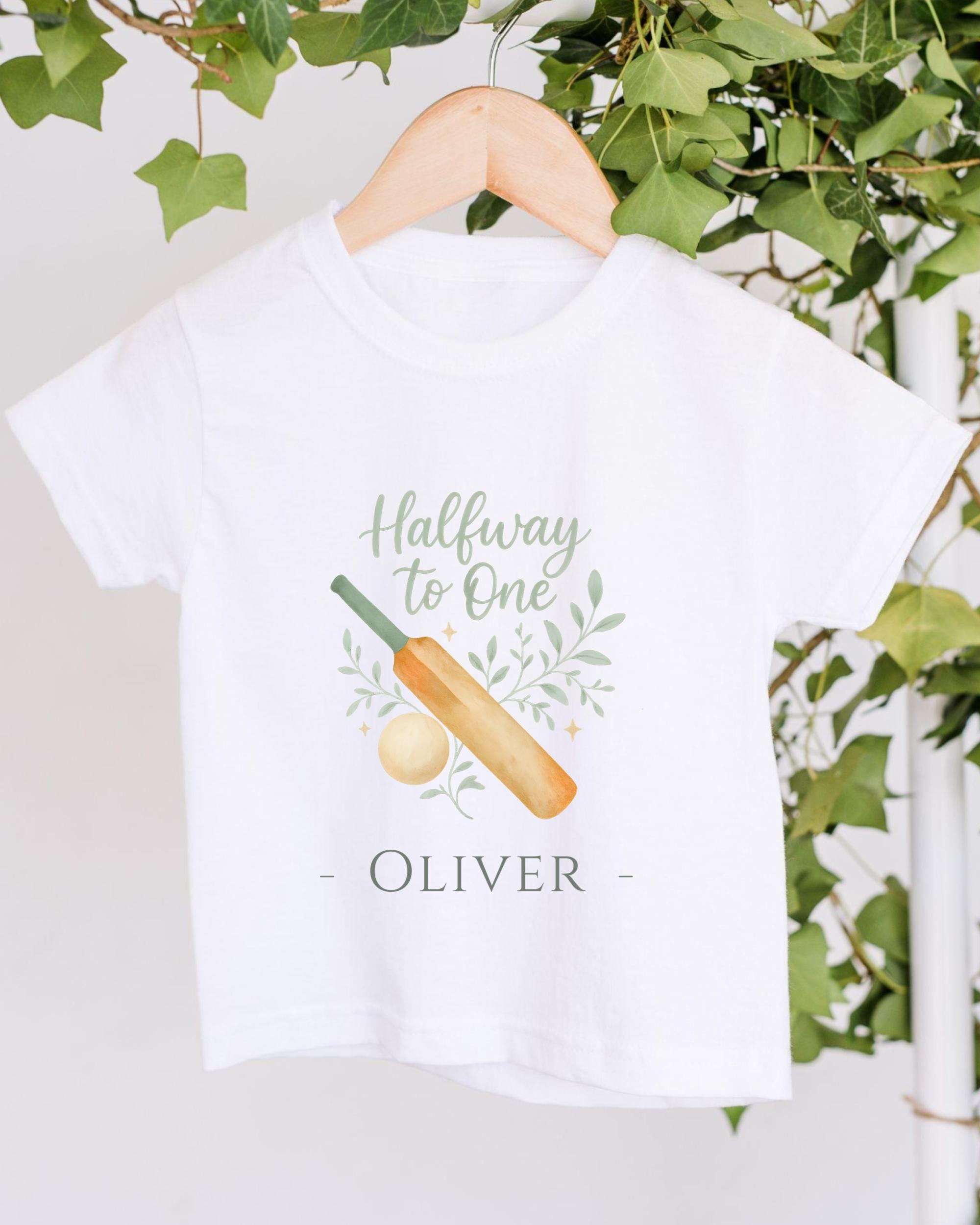 A white t-shirt with a graphic design and text printed on it, hanging on a wooden hanger.