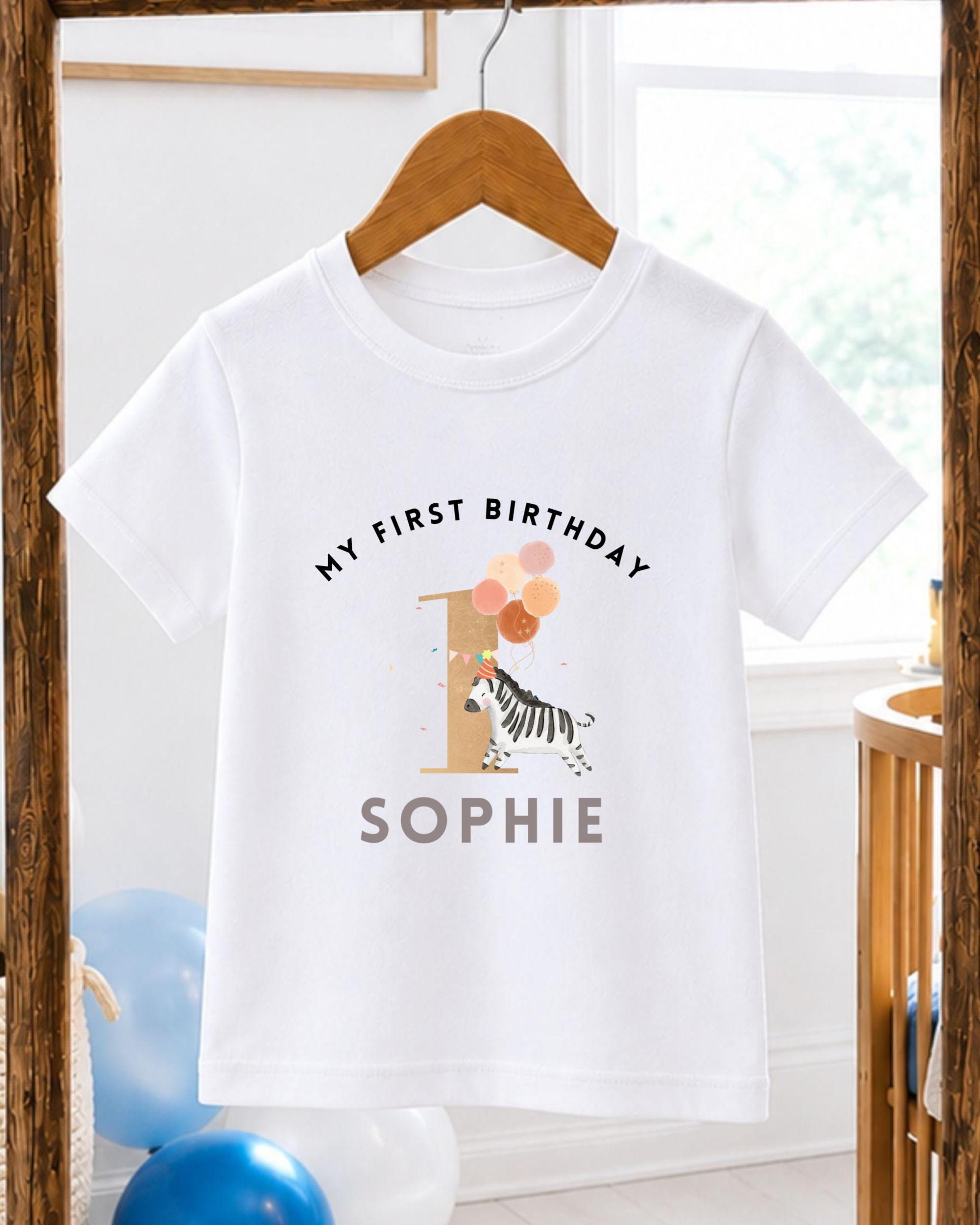A white t-shirt with a graphic design and text printed on it, hanging on a wooden hanger.