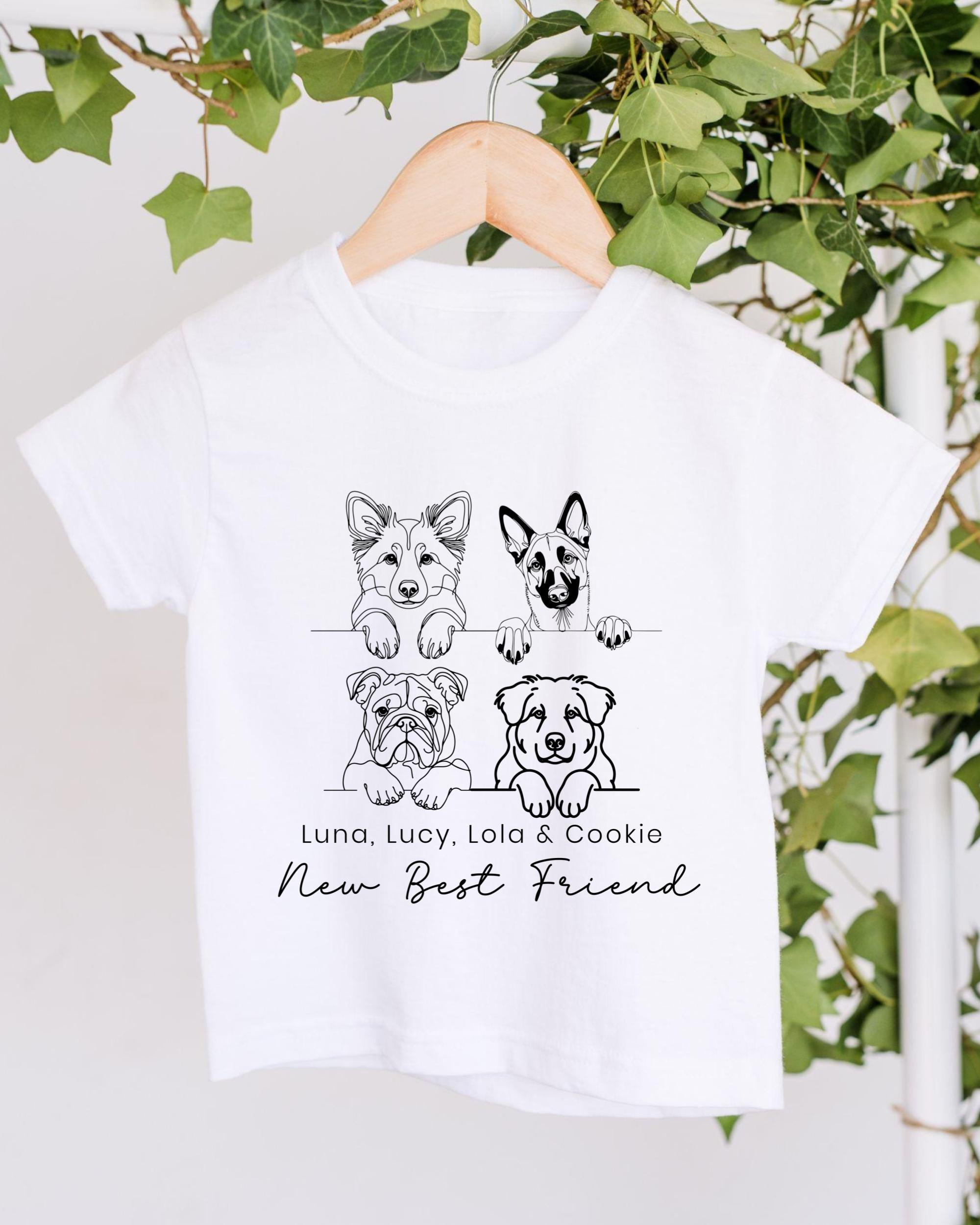A white t-shirt with a graphic design featuring four cartoon dog illustrations and the text "New Best Friend" below them.