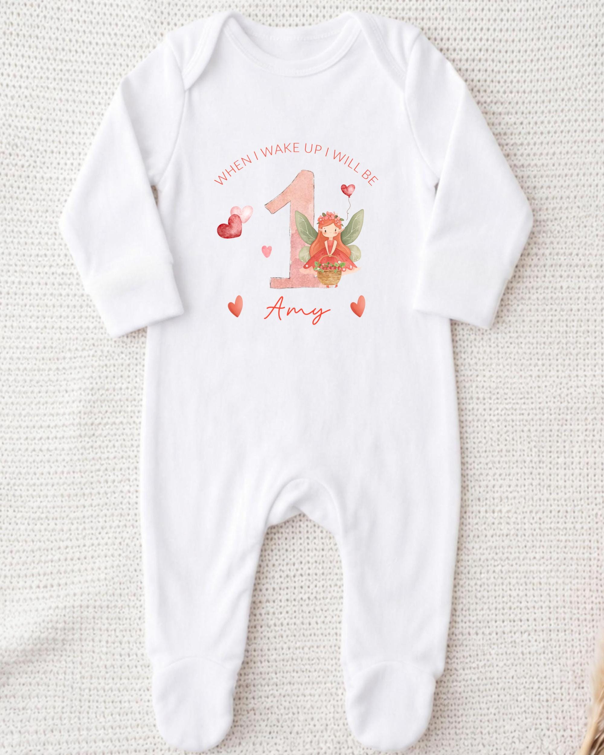 A white onesie with a personalized design and text printed on it.