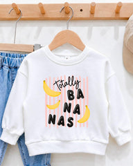 A white sweatshirt with a playful graphic design featuring bananas and the text "Totally BANANA" printed on it.