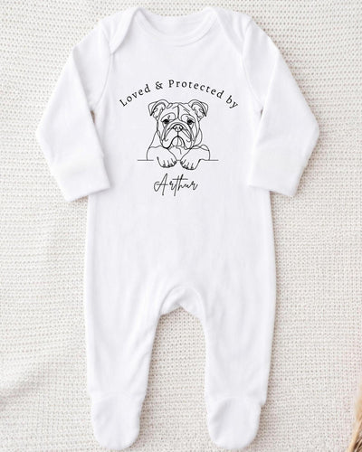 A white bodysuit with a black illustration of a bulldog and the text "Loved & Protected by Arthur" printed on it.