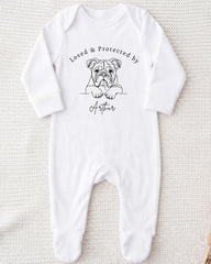 A white onesie with a black illustration of a bulldog and the text "Loved & Protected by Arthur" printed on it.