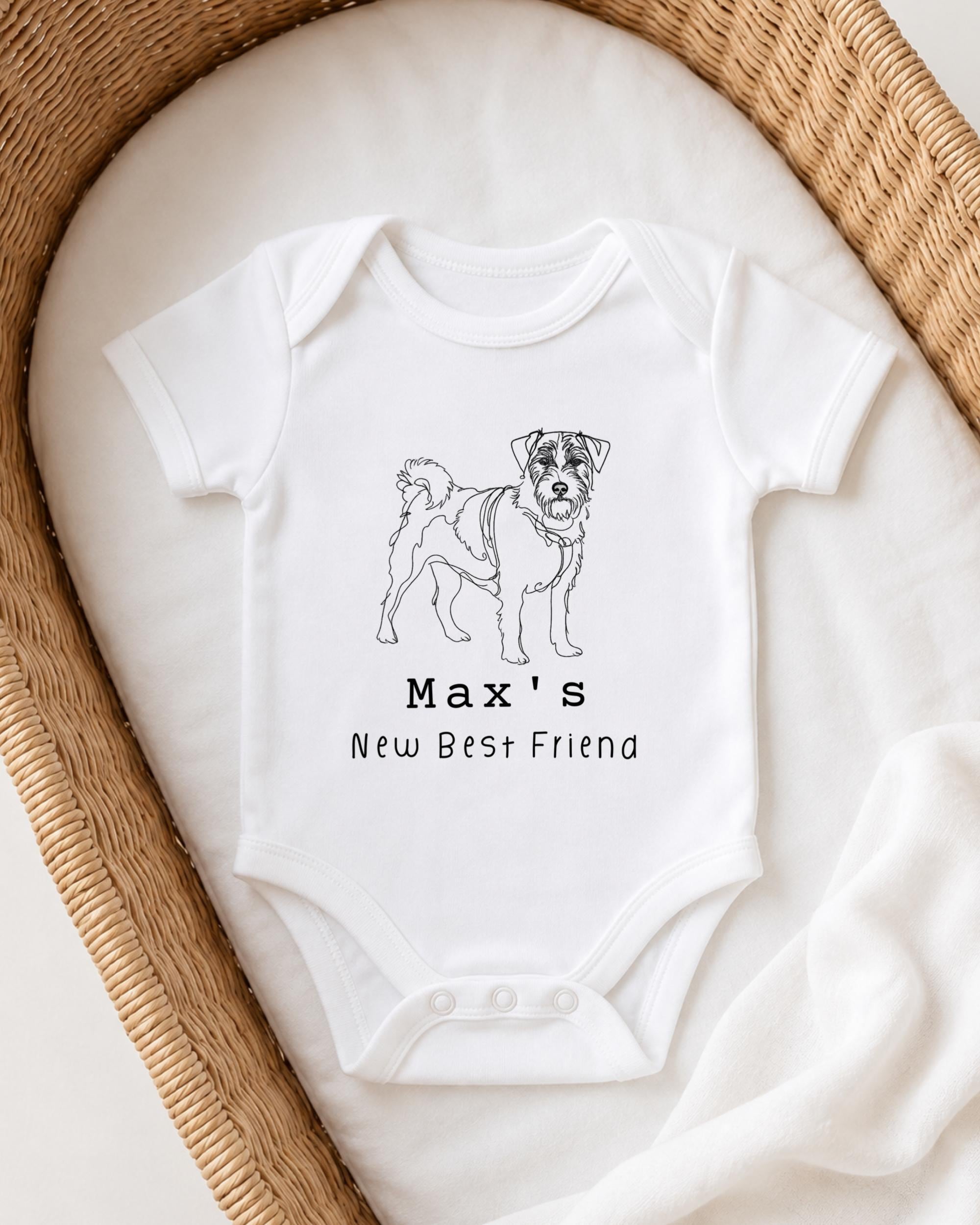 A white onesie with a black dog illustration and the text "Max's New Best Friend" printed on it.