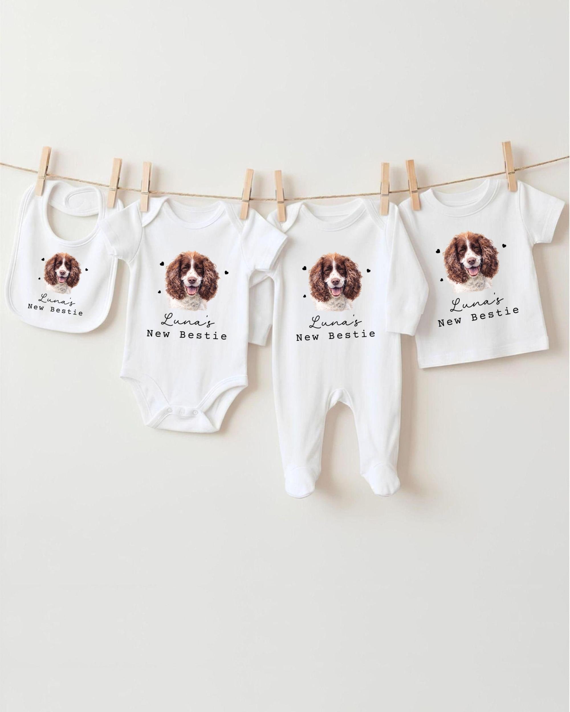 A collection of baby clothes and bibs featuring a dog image, with the text "Luna's New Bestie" printed on them.