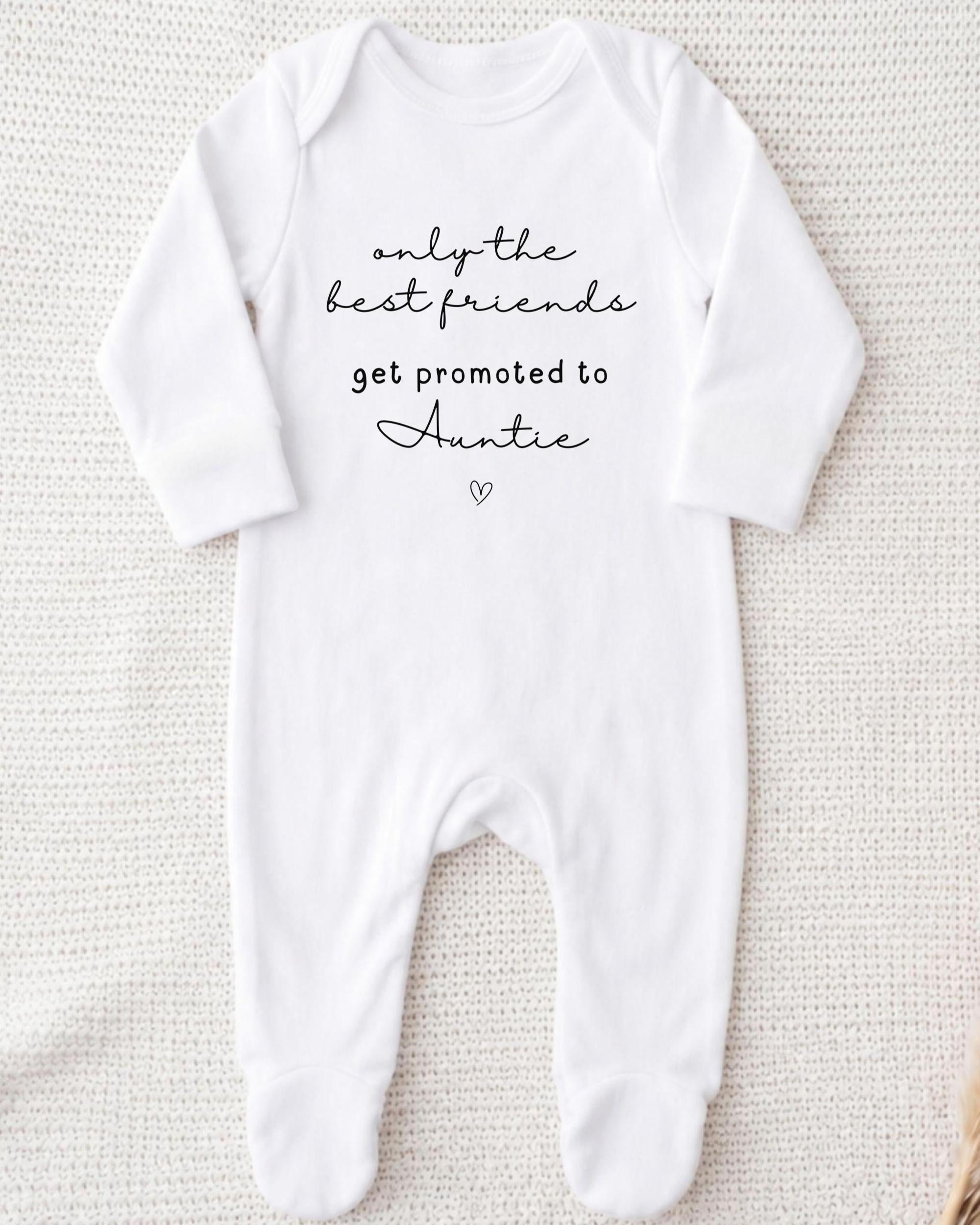 A white onesie with the text "only the best friends get promoted to Auntie" printed on it.