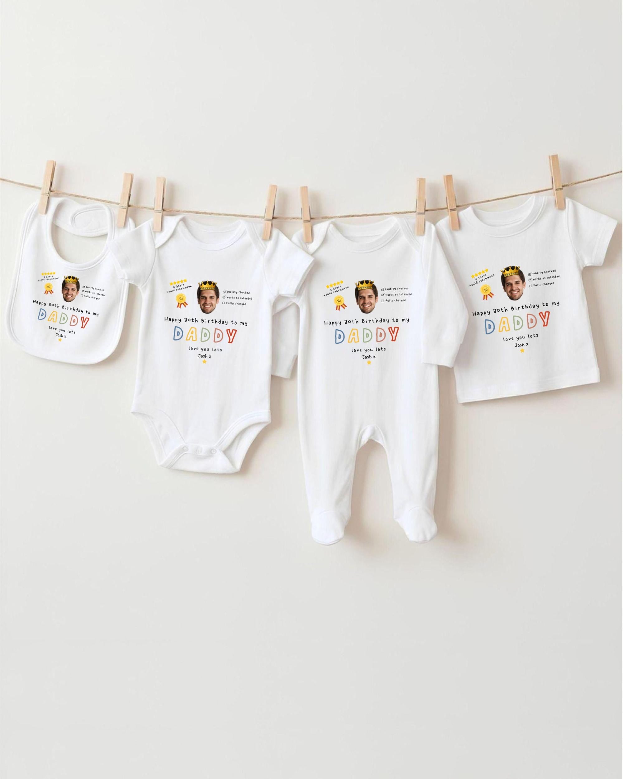 a collection of white baby clothes, including onesies and bibs, hanging on a clothesline.